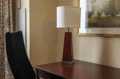 a lamp sitting on a desk with a chair at The Conwell Inn in Philadelphia