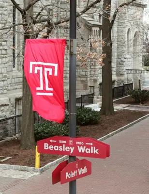 a red flag on a pole with a street sign at The Conwell Inn in Philadelphia