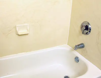 a white bath tub with a faucet in a bathroom at The Conwell Inn in Philadelphia