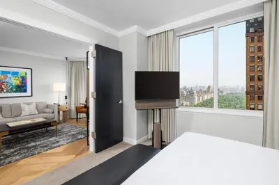 a hotel room with a bed and a tv at The Luxury Collection Hotel Manhattan Midtown in New York