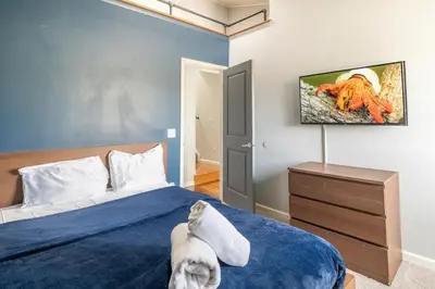 a bedroom with a bed and a tv on the wall at Cobalt in Lake Harmony