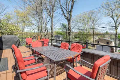 a patio with a table and chairs on a deck at Cobalt in Lake Harmony