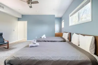 two beds in a bedroom with a blue wall at Cobalt in Lake Harmony