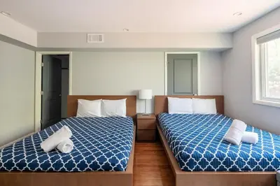 two beds in a room with blue and white at Cobalt in Lake Harmony