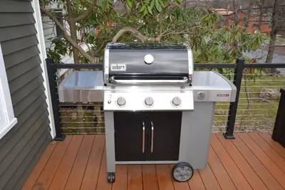 a grill sitting on a deck next to a house at Cobalt in Lake Harmony