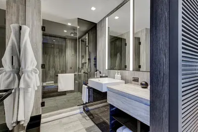 a bathroom with a sink and a shower at Equinox Hotel New York in New York