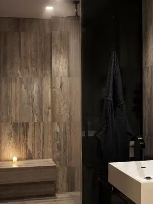 a bathroom with a sink and a wooden wall at Equinox Hotel New York in New York