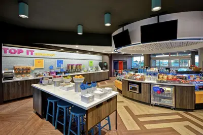 a fast food restaurant with a top it counter at Tru By Hilton Denver, PA in Denver