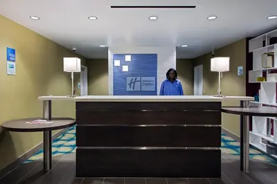 a woman standing at a counter in a hospital lobby at Holiday Inn Express & Suites Carlisle - Harrisburg Area by IHG in Carlisle
