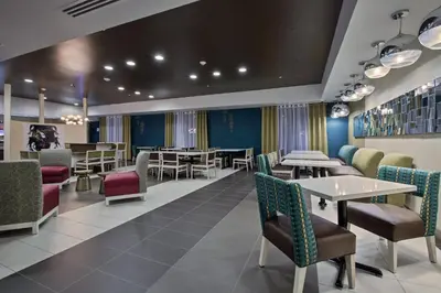 a dining room with tables and chairs and tablesktop at Holiday Inn Express & Suites Carlisle - Harrisburg Area by IHG in Carlisle