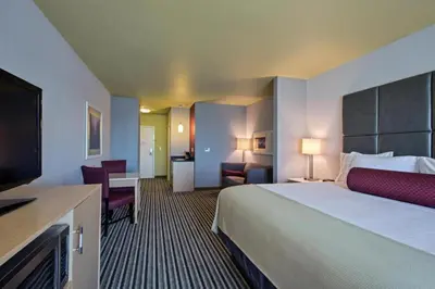 a hotel room with a large bed and a television at Holiday Inn Express & Suites Carlisle - Harrisburg Area by IHG in Carlisle
