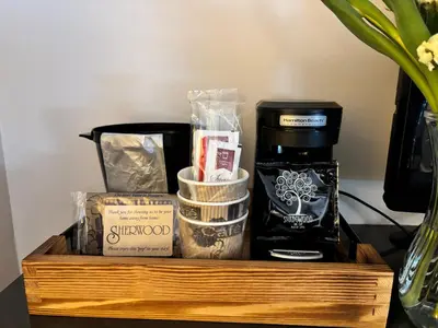 a wooden tray with a coffee maker and other items at SHERWOOD MOTEL in Wellsboro