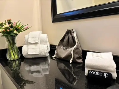 a table with towels and a bag on top of it at SHERWOOD MOTEL in Wellsboro