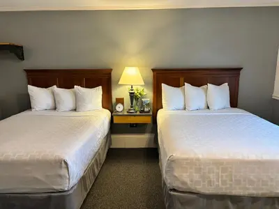 a hotel room with two beds and a lamp at SHERWOOD MOTEL in Wellsboro