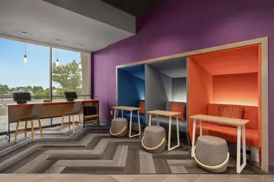 a room with tables and chairs and a desk at Tru By Hilton Hershey Chocolate Avenue in Hershey