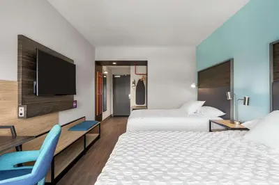 a hotel room with two beds and a flat screen tv at Tru By Hilton Hershey Chocolate Avenue in Hershey