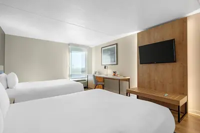 a hotel room with two beds and a flat screen tv at Radisson Hotel Philadelphia Northeast in Trevose