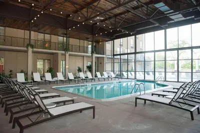 a large swimming pool with chairs and a large building at Radisson Hotel Philadelphia Northeast in Trevose