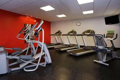 a gym with a row of treadmills in a room at Radisson Hotel Philadelphia Northeast in Trevose