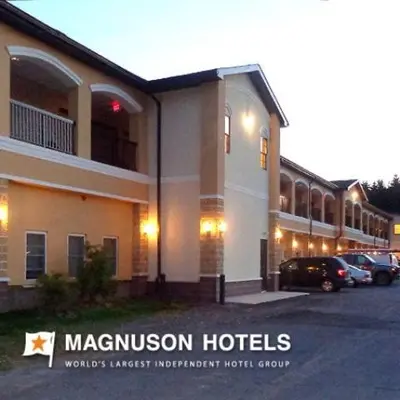 a large hotel with cars parked in front of it at Budget Inn Williamsport in Williamsport