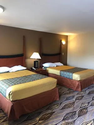 a hotel room with two beds in a room at Budget Inn Williamsport in Williamsport