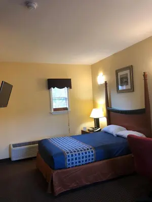 a hotel room with a bed and a window at Budget Inn Williamsport in Williamsport