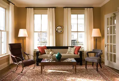 a living room with a couch and chairs and windows at Hotel Fauchere in Milford