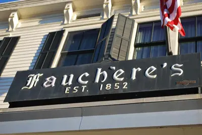 a sign on a building with a british flag at Hotel Fauchere in Milford