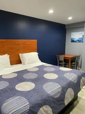 a bedroom with a large bed and a table at Dunmore Inn in Dunmore