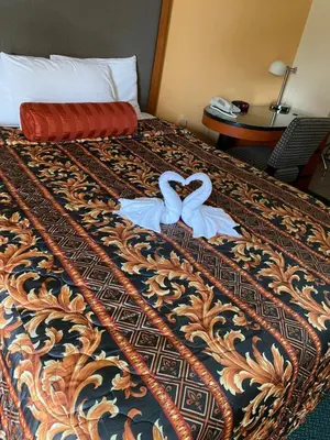 two swans towels on a bed in a hotel room at Sentinel Motel in West Chester
