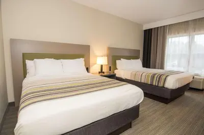 a hotel room with two beds and a window at Country Inn & Suites by Radisson, Lehighton-Jim Thorpe, PA in Lehighton