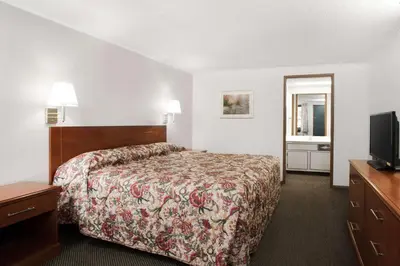 a hotel room with a bed and a television at Knights Inn Pittston in Pittston