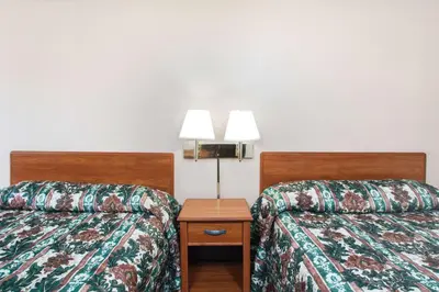 a hotel room with two beds and a lamp at Knights Inn Pittston in Pittston