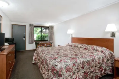 a hotel room with a bed and a television at Knights Inn Pittston in Pittston