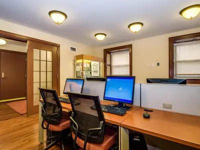 an office with a desk with three computers on it at Leo House in New York