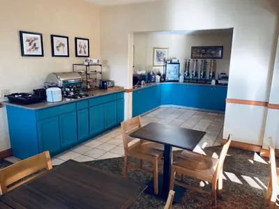 a kitchen with blue cabinets and a table and chairs at Country Inn & Suites by Radisson, York, PA in York