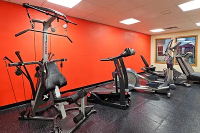a gym with several cardio machines in a room at Country Inn & Suites by Radisson, York, PA in York
