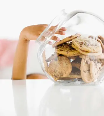 a person holding a glass container filled with cookies at Country Inn & Suites by Radisson, York, PA in York