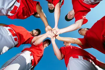 a group of baseball players holding their hands together at Country Inn & Suites by Radisson, York, PA in York