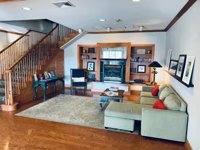 a living room with a couch and a staircase at Country Inn & Suites by Radisson, York, PA in York