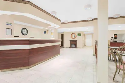 a lobby of a hospital with a clock on the wall at Microtel Inn & Suites by Wyndham Hamburg in Hamburg