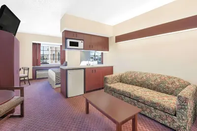 a living room with a couch and a table at Microtel Inn & Suites by Wyndham Hamburg in Hamburg