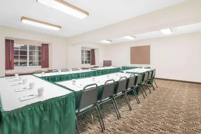 a conference room with tables and chairs and a podium at Microtel Inn & Suites by Wyndham Hamburg in Hamburg
