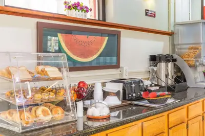 a kitchen counter with a bunch of bread and pastries at Econo Lodge Clarks Summit - Scranton in Clarks Summit
