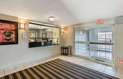 a lobby with a exit sign on the wall at Extended Stay America Select Suites - Wilkes - Barre - Scranton in Wilkes-Barre