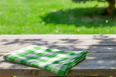 a green and white pillow sitting on a wooden table at Extended Stay America Select Suites - Wilkes - Barre - Scranton in Wilkes-Barre