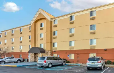 two cars parked in a parking lot in front of a building at Extended Stay America Select Suites - Wilkes - Barre - Scranton in Wilkes-Barre