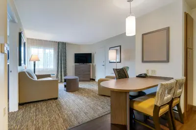 a living room with a dining table and a living room at Candlewood Suites Reading by IHG in Reading