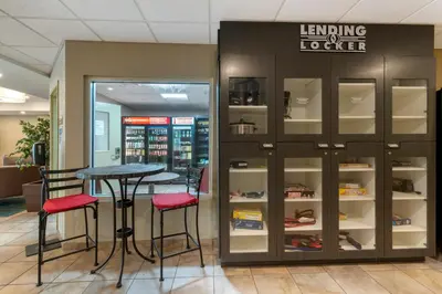 a restaurant with a table and stools in a store at Candlewood Suites Reading by IHG in Reading