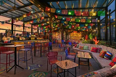 a restaurant with tables and chairs and a bar at Moxy NYC East Village in New York